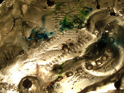 Cast glass with metal includes